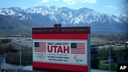As members of the International Olympic Committee prepare to visit Salt Lake City's stadium and other venues on April 10, 2024, a scoreboard at the University of Utah promotes Salt Lake City's bid to host another Winter Olympics in 2034.