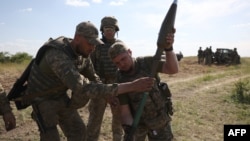 ডনেটস্ক অঞ্চলে যুদ্ধক্ষেত্রের কাছাকাছি জায়গায় সামরিক প্রশিক্ষণ মহড়ার সময় একজন ইউক্রেনীয় সেনা রকেট লঞ্চারের ব্যবহার শিখছেন (৮ জুন, ২০২৩) 