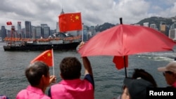 一艘渔船驶过香港维多利亚港，庆祝这个前英国殖民地主权移交中国27周年。(2024年7月1日)