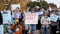 FILE - Activists demonstrate as the Supreme Court hears oral arguments on a pair of cases that could decide the future of affirmative action in college admissions, in Washington, Oct. 31, 2022.