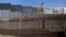 FILE - A US flag flies behind the border fence that divides Mexico and the US, in Tijuana, Mexico, Nov. 21, 2018.