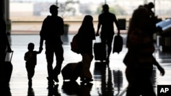 People travel through Salt Lake City International Airport, June 30, 2023, in Salt Lake City. 