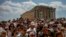 Atop the Acropolis ancient hill, tourists visit the Parthenon temple, background, in Athens, Greece, July 4, 2023.