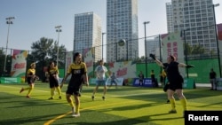 Players of team Infinite and team Anejo compete in a friendly amateur soccer tournament in Beijing, July 16, 2023.