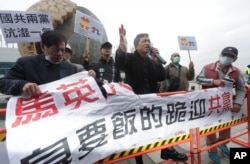 Protesters shout slogans as former Taiwan President Ma Ying-jeou leaves for China outside of Taoyuan International Airport in Taoyuan City, Northern Taiwan, March 27, 2023.