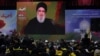 Pemimpin Hizbullah Lebanon Sayyed Hassan Nasrallah menyapa para pendukungnya secara vitual dalam sebuah acara di Beirut, pada 11 November 2023. (Foto: Reuters/Aziz Taher)