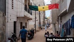 A large Senegalese flag hangs across a street in a neighborhood in Dakar on Tuesday February 13, 2024.