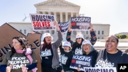 Activists demonstrate at the Supreme Court as the justices consider a challenge to rulings that found punishing people for sleeping outside when shelter space is lacking amounts to unconstitutional cruel and unusual punishment, in Washington, Monday, April 22, 2024.