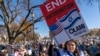 A woman holds a sign calling for an end to antisemitism while attending a March for Israel rally Nov. 14, 2023, on the National Mall in Washington. 