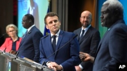 FILE - African Union Commission Chair Mahamat Moussa Faki, right, speaks during a media conference at the conclusion of an EU-AU summit in Brussels, Feb. 18, 2022.