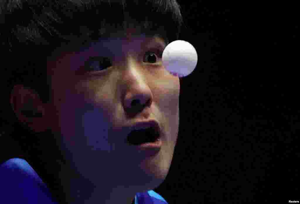 Japan&#39;s Tomokazu Harimoto serves the ball to Austria&#39;s Andreas Levenko during the ITTF World Team Table Tennis championships Finals in Busan, South Korea.