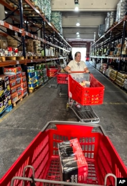A shopper pushes her cart at a private grocery store that has come to be known as the “Cuban Costco” in Havana on Nov. 9, 2023.