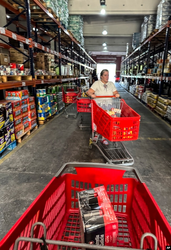 A shopper pushes her cart at a private grocery store that has come to be known as the “Cuban Costco” in Havana on Nov. 9, 2023.