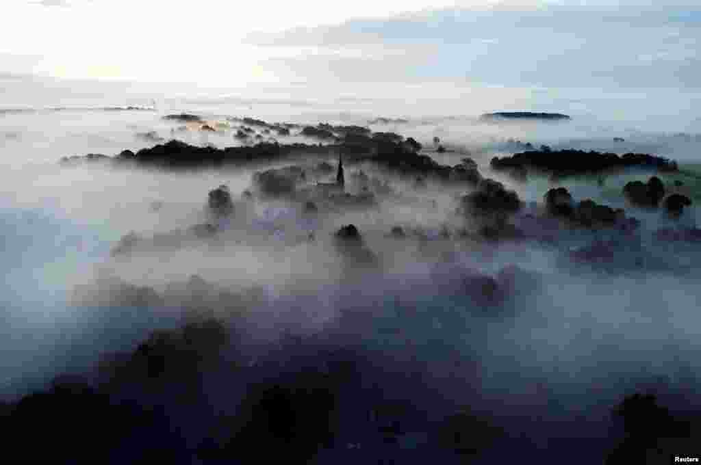 The Church of St John the Baptist is shrouded in fog, Keele, Staffordshire, Britain.