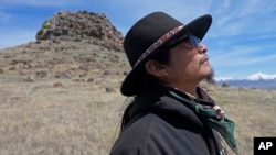 FILE - Gary McKinney, a spokesperson for People of Red Mountain and a member of the nearby Duck Valley Shoshone-Paiute Tribe, walks near Sentinel Rock, April 25, 2023, outside of Orovada, Nev.