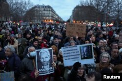 People hold banners as they gather in support of WikiLeaks founder Julian Assange at the Place de la Republique in Paris, on the day Assange appeals in a British court against his extradition to the United States, in Paris, France, Feb. 20, 2024.