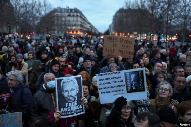 People hold banners as they gather in support of WikiLeaks founder Julian Assange at the Place de la Republique in Paris, on the day Assange appeals in a British court against his extradition to the United States, in Paris, France, Feb. 20, 2024.