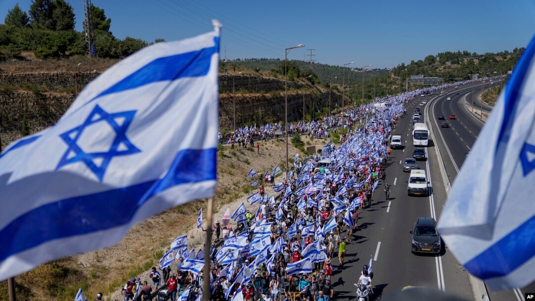 Thousands of Israelis march along a highway toward Jerusalem in protest of plans by Netanyahu's government to overhaul the judicial system, near Abu Gosh, Israel, July 22, 2023.