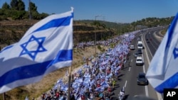 Thousands of Israelis march along a highway toward Jerusalem in protest of plans by Netanyahu's government to overhaul the judicial system, near Abu Gosh, Israel, July 22, 2023.