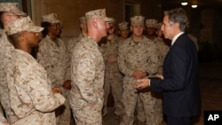 FILE - U.S. Secretary of State Antony Blinken exchanges challenge coins with the U.S. Marine Corps embassy security guard detachment in Baghdad, Iraq on Sunday November 5, 2023. 