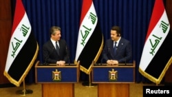 Iraqi Prime Minister Mohammed Shia al-Sudani, right, and Masrour Barzani, prime minister of Iraq's semi-autonomous Kurdish region holds a joint news conference in Baghdad, Iraq, April 4, 2023. (Iraqi Prime Minister Media Office/Handout via Reuters) 