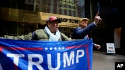 A supporter of former President Donald Trump, and a man impersonating the former president stand outside of Trump Tower on March 31, 2023, in New York.