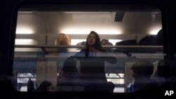 A woman looks out the window of the Kyiv-Kramatorsk train before its departure, at the railway station in Kyiv, Ukraine, Sept. 12, 2023.