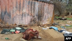 FILE - A picture taken June 16, 2023, shows covered bodies strewn near houses in the West Darfur capital El Geneina, amid ongoing fighting in war-torn Sudan.