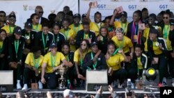 FILE - South Africa's women's soccer team poses for photographers and fans during a welcome ceremony at the OR Tambo International Airport in Johannesburg, South Africa, July 26, 2022.