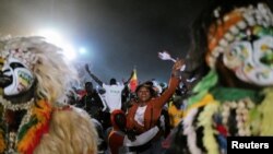 FILE - Senegal’s fans celebrate after winning the Africa Cup of Nations 2021 final match between Egypt and Senegal in Dakar, Senegal February 6, 2022.