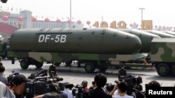 FILE - Military vehicles carrying DF-5B intercontinental ballistic missiles travel past Tiananmen Square during a military parade in Beijing, China, Oct. 1, 2019. 