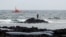FILE - Rescuers look for bodies after a boat with 46 migrants from the Maghreb region capsized off Orzola, on Lanzarote island, June 18, 2021. Nearly 32,000 migrants have reached the Canary Islands from West Africa in 2023, authorities said Nov. 5, 2023.