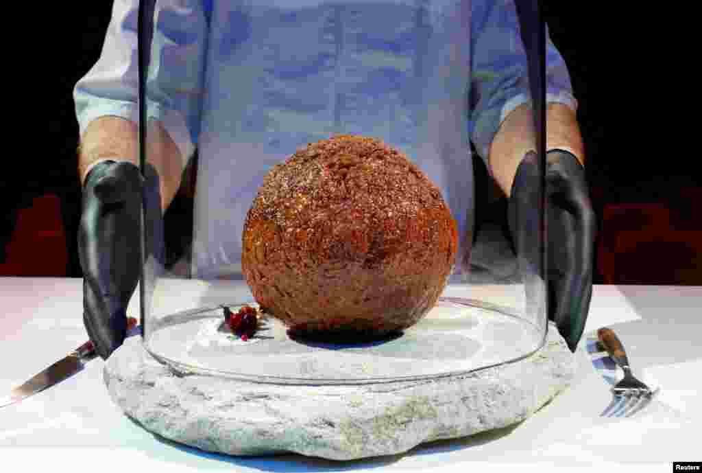 A meatball made from flesh cultivated using the DNA of an extinct woolly mammoth is presented at NEMO Science Museum created by a cultured meat company, in Amsterdam, Netherlands, March 28, 2023.