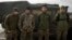 FILE - Colombian veterans who joined the Ukrainian armed forces to help fight Russia pose for a photo near their Humvee on the front line near Lyman, Donetsk region, Ukraine, Jan. 29, 2024. 