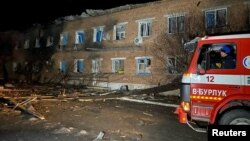 FILE - A fire truck next to a building damaged following a bomb blast, amid Russia's attack on Ukraine, in Velykyi Burluk, Kharkiv region, Ukraine, in this handout image released on Feb. 1, 2024. (State Emergency Service of Ukraine/Handout via Reuters) 