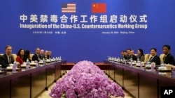 U.S. Deputy Assistant to the President and Deputy Homeland Security Advisor Jen Daskal, second from left, and Chinese Minister of Public Security Wang Xiaohong, second from right, look towards cameras in Beijing, Jan. 30, 2024.