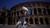 A tourist uses a fan to shelter from the sun near the Colosseum during a heatwave in Rome, July 11, 2023. The beginning of July was Earth's hottest week on record, according to early findings on July 10 from the World Meteorological Organization.