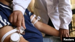 FILE - A man undergoes a medical examination to prevent Chagas disease in the Argentine province of Corrientes in this picture taken Sept. 16, 2008. 