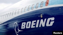 FILE - The Boeing logo is seen on the side of a Boeing 737 MAX at the Farnborough International Airshow in Farnborough, Britain, July 20, 2022. 