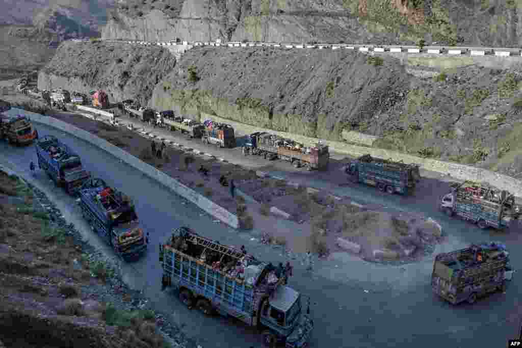 Trucks transporting Afghan refugees with their belongings are seen along a road towards the Pakistan-Afghanistan Torkham border, following Pakistan's government decision to expel people illegally staying in the country. 