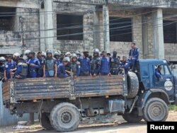 Riot police stand on their truck during a protest against Western partners in front of the U.S. embassy in downtown Kinshasa, Democratic Republic of Congo, Feb. 12, 2024.