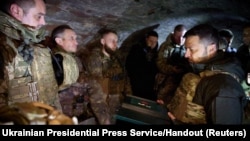 Ukraine's President Volodymyr Zelenskiy awards service members during his visit at a frontline, amid Russia's attack on Ukraine, in the Zaporizhzhia region, Feb. 4, 2024. 