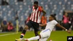 FILE - Athletic Bilbao's Inaki Williams, left, and Real Madrid's David Alaba fight for the ball during the Spanish Super Cup final soccer match between Real Madrid and Athletic Bilbao at King Fahd stadium in Riyadh, Saudi Arabia, Sunday, January 16, 2022.