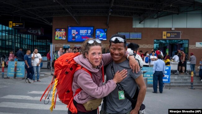 Norwegian climber Kristin Harila, 37, right, and her guide Tenjen Sherpa pose for a photograph in Kathmandu, Nepal, Tuesday, June 6, 2023. The Norwegian who is aiming to be the fastest climber to scale all the world's 14 highest mountains announced she is shortening her goal and do it in half the time than initial target. (AP Photo/Niranjan Shrestha)