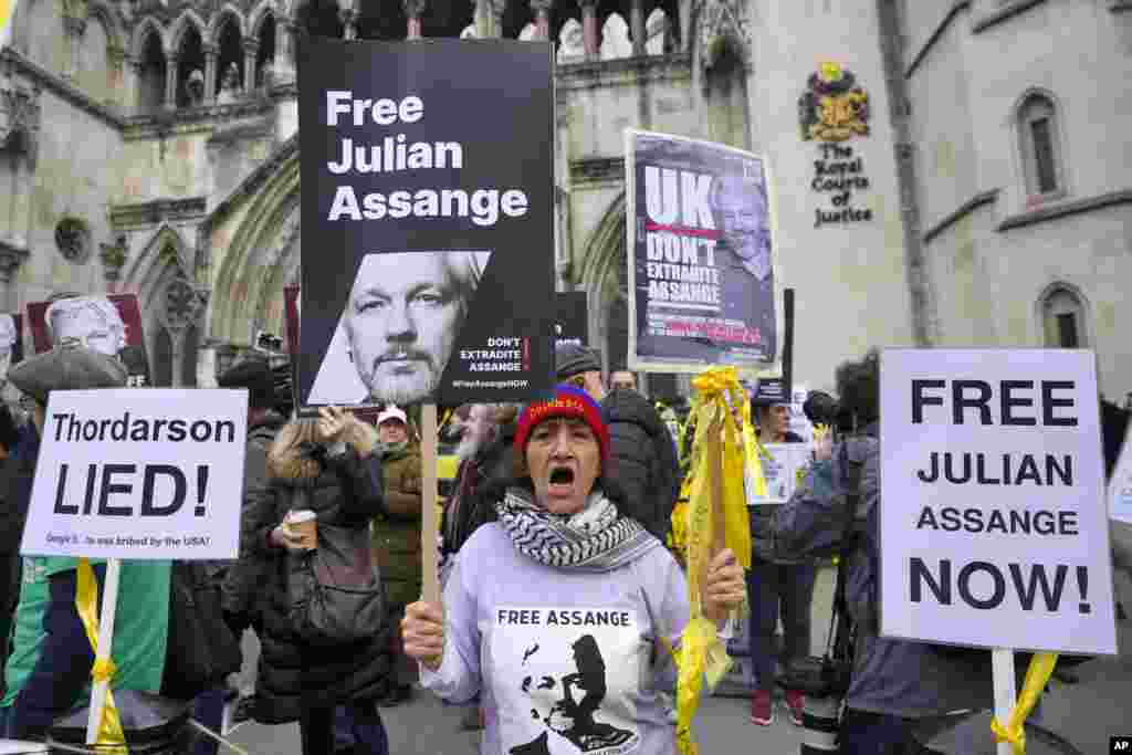 Demonstrators hold banners outside the Royal Courts of Justice in London.&nbsp;WikiLeaks founder Julian Assange will make his final appeal against his impending extradition to the United States at the court.&nbsp;