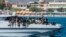 New migrants arrive on a Guardia di Finanza ship, in the Lampedusa harbor, Sept. 15, 2023. Good weather has seen a surge in arrivals across Italy in recent days, with more than 8,000 people landing in recent days.