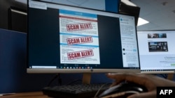 FILE - A researcher browses an internet site with a job offer for a United Nations agency that has been flagged as a scam in Nairobi, Kenya on June 30, 2022. 