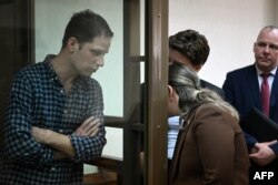 U.S. journalist Evan Gershkovich is seen inside a defendants' cage before a hearing to consider an appeal on his arrest at the Moscow City Court in Moscow, Russia, Apr. 18, 2023.