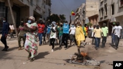 Demonstrators protest President Macky Sall's decision to postpone the Feb. 25 presidential election, in Dakar, Senegal, Feb. 9, 2024.