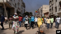 FILE - Demonstrators protest President Macky Sall's decision to postpone the Feb. 25 presidential election, in Dakar, Senegal, Feb. 9, 2024.